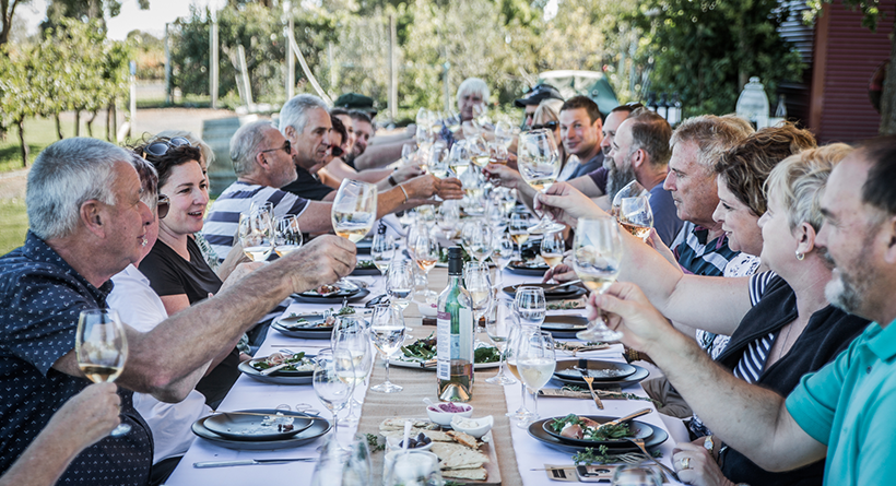 Group of family and friends enjoying food and wine at Raidis Estate